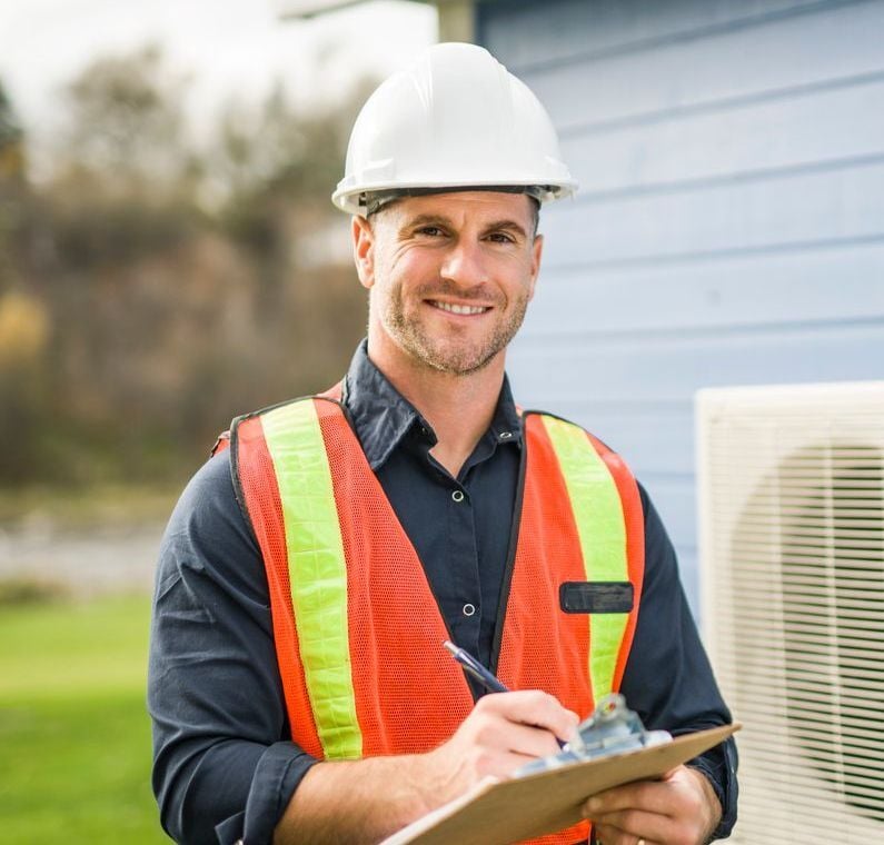 Smiling field services HVAC technician after servicing home and easily getting paid via an online invoice payment