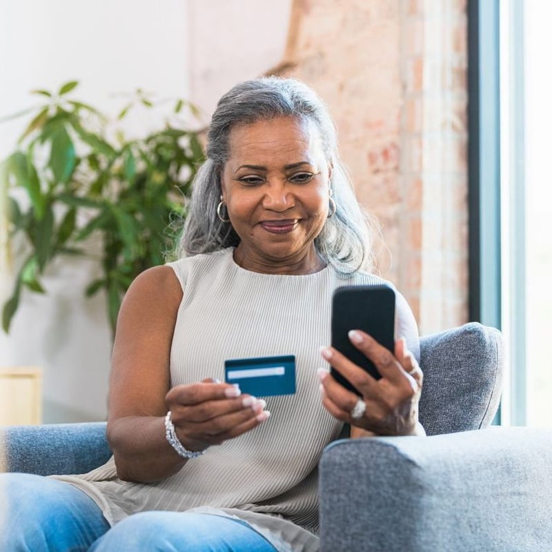 Customer easily entering credit card payment on iphone for an online shopping cart eCommerce transaction which can also accept Apple Pay